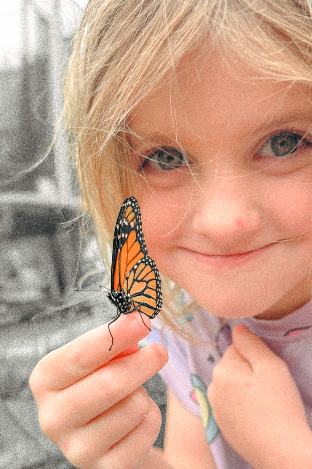 girl holding monarch